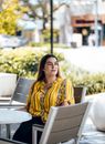 Woman in Yellow Dress Sitting on Wooden Bench