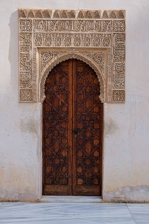 Free Beautifully carved wooden door at Alhambra showcasing Islamic architectural details in Granada, Spain. Stock Photo