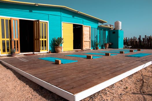 Discover tranquility at this vibrant yoga retreat in Taghazout, Morocco, with turquoise and yellow accents.