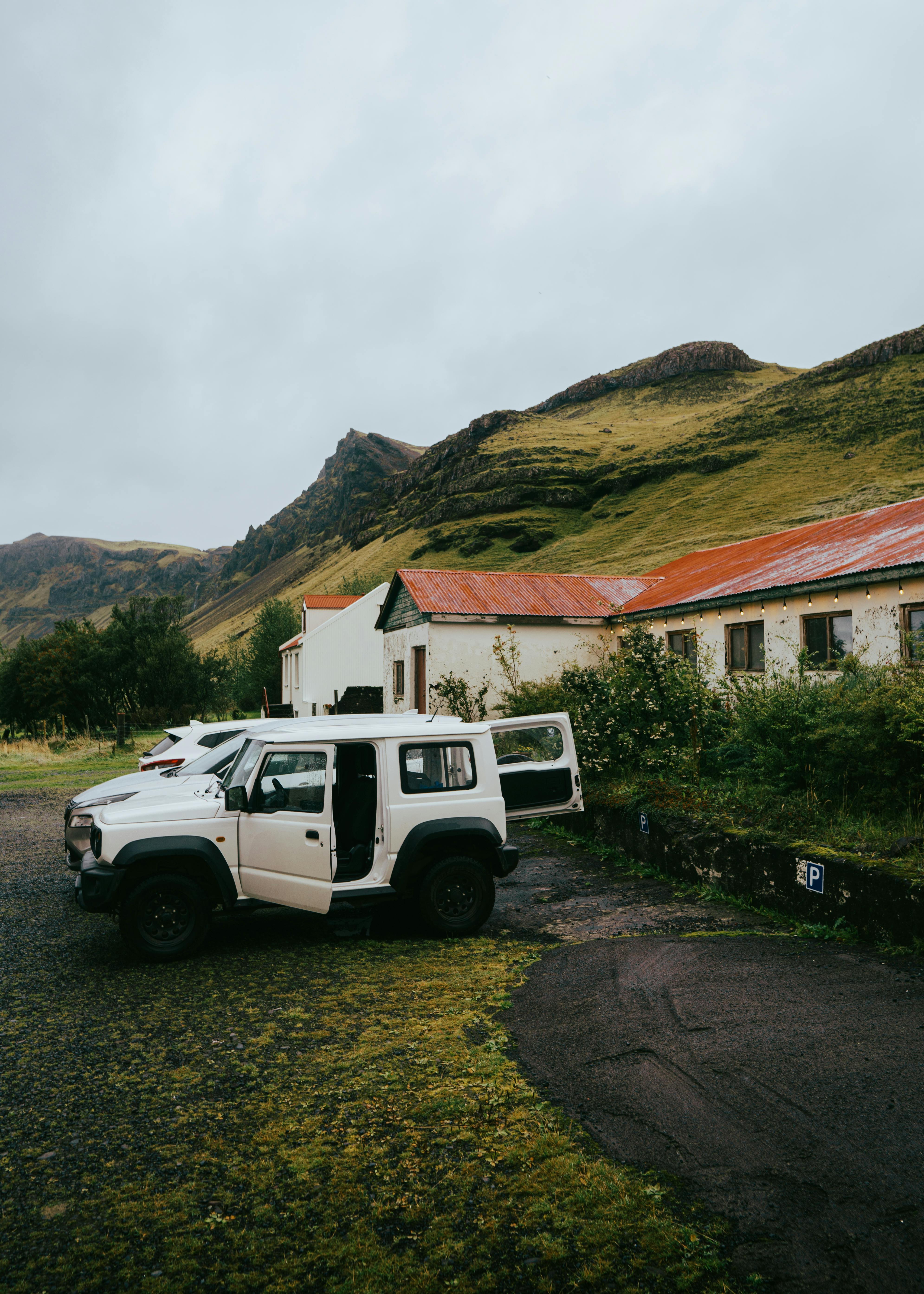 SUV parked in an Icelandic mountain landscape with panoramic views of wild nature