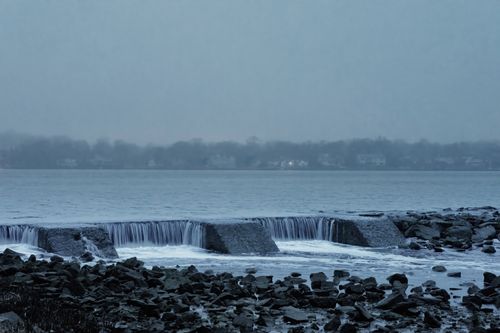 Free Peaceful waterfall at Cove Island Park in Stamford, Connecticut during a foggy dawn in spring. Stock Photo
