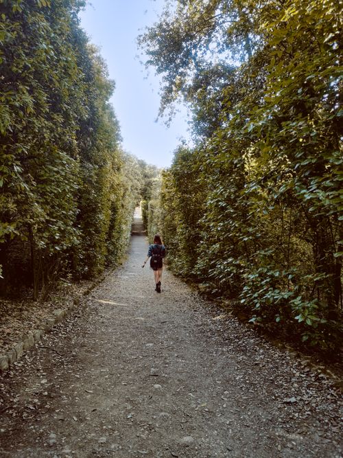 Free A solitary hiker enjoys a peaceful trek on a leafy path in Florence, Italy. Stock Photo