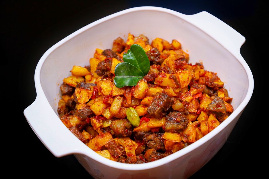 Delicious Indonesian Sambal Goreng Ati prepared with spices and herbs, served in a white dish.