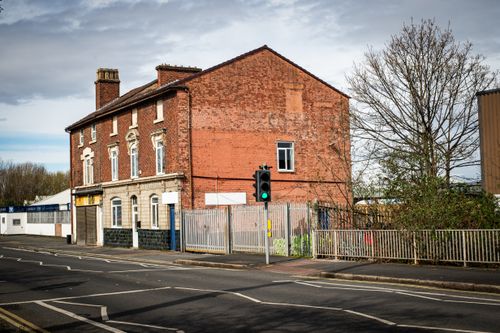 Free A vintage brick building with urban surroundings in Liverpool, UK, showcasing traditional architecture. Stock Photo