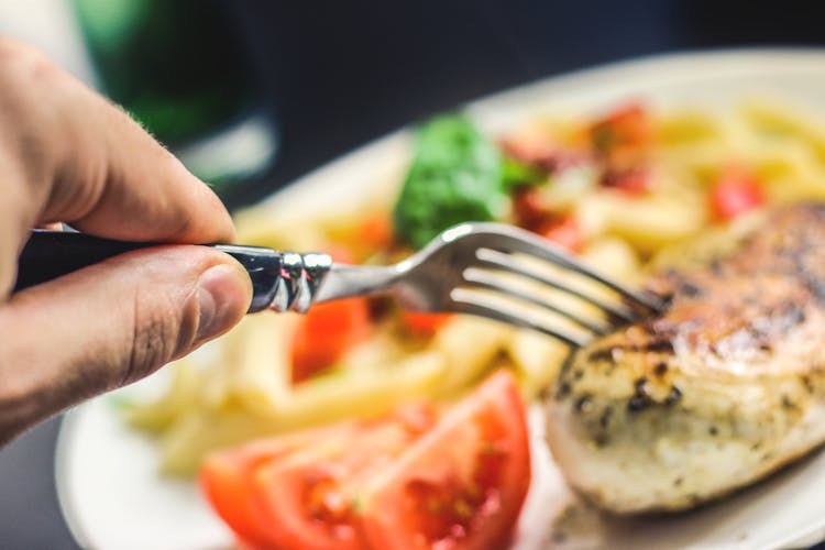 Person Holding Silver Fork