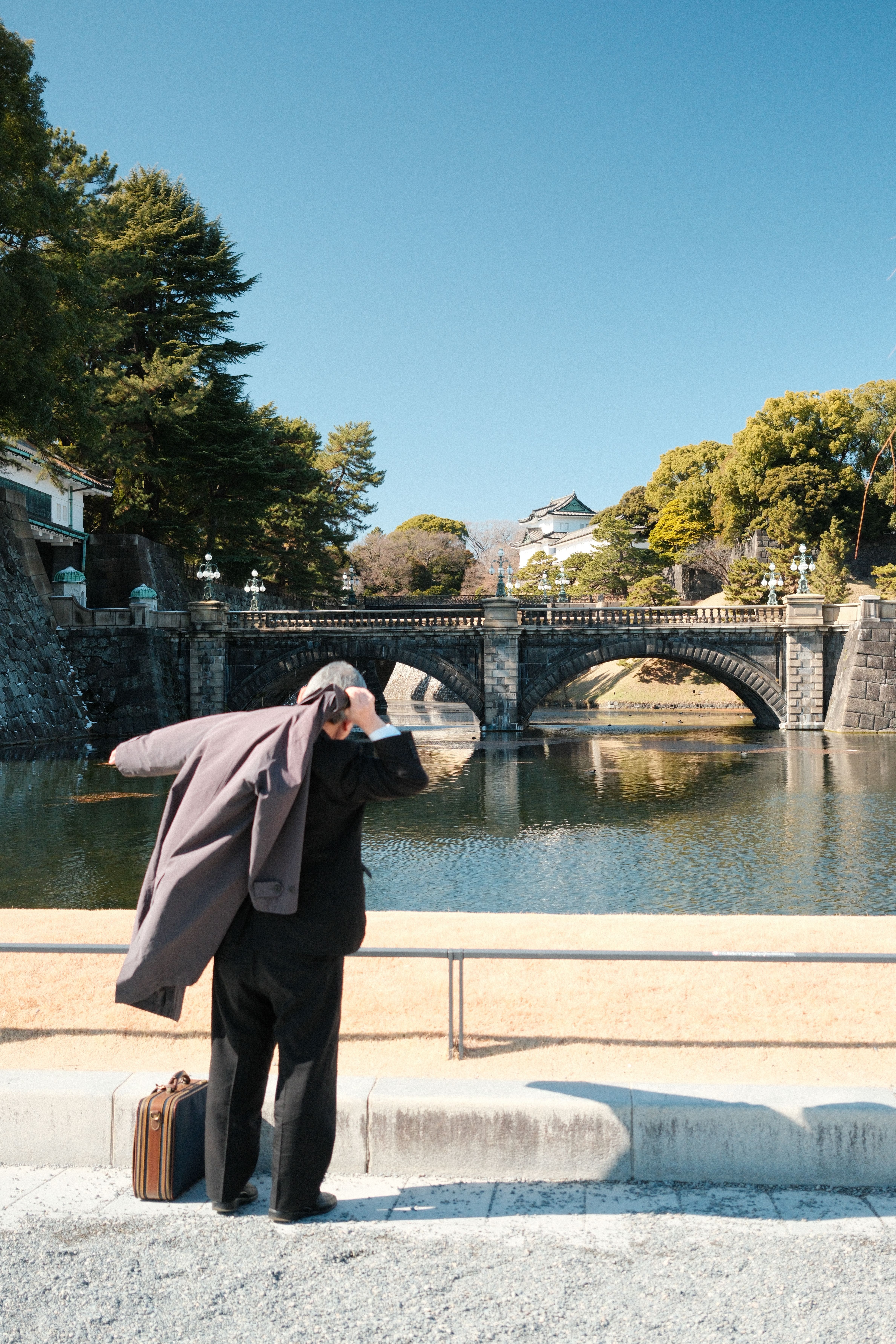 Man Enjoying View of Historic Bridge in Tokyo · Free Stock Photo