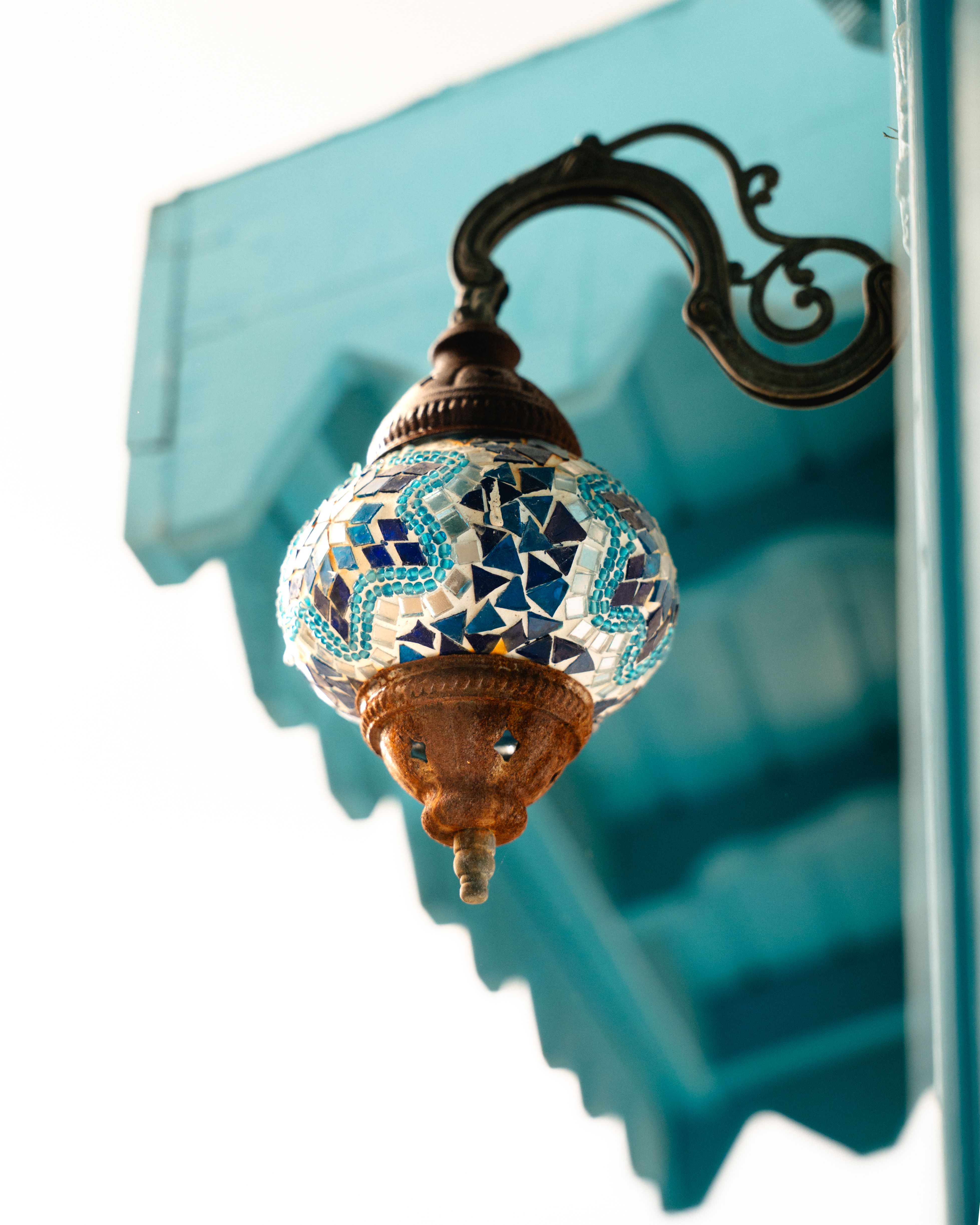 Ornate Turkish mosaic lamp hanging outdoors in Marmaris, Türkiye.