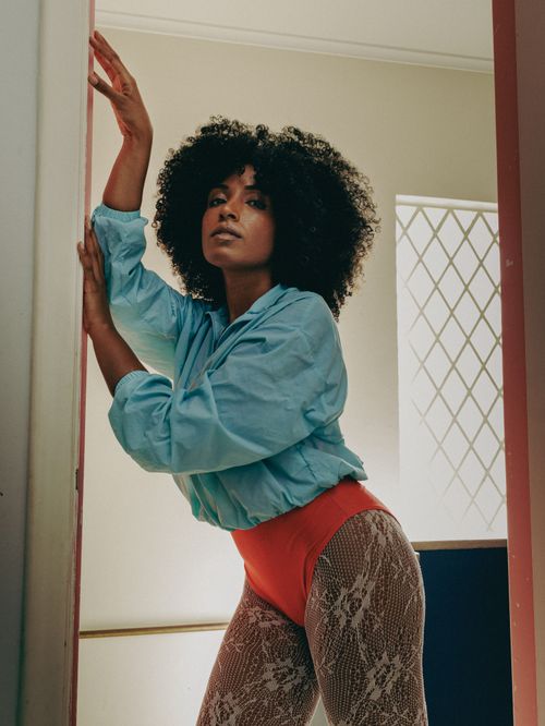 Free Trendy woman posing indoors with vibrant fashion in São Paulo apartment. Stock Photo