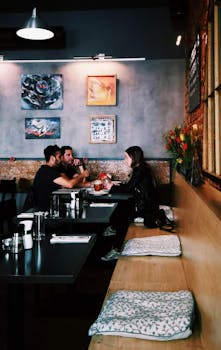 在时尚的布拉格咖啡馆里，一群人正谈笑风生，周围环绕着艺术与鲜花