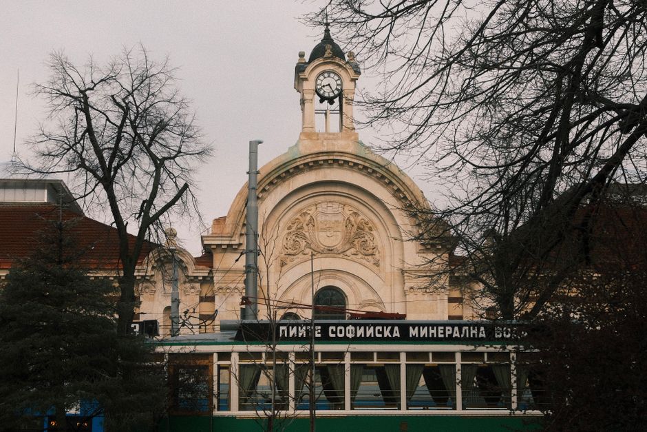 Beautiful architectural view of Sofia Central Mineral Baths with bare trees and a winter atmosphere.