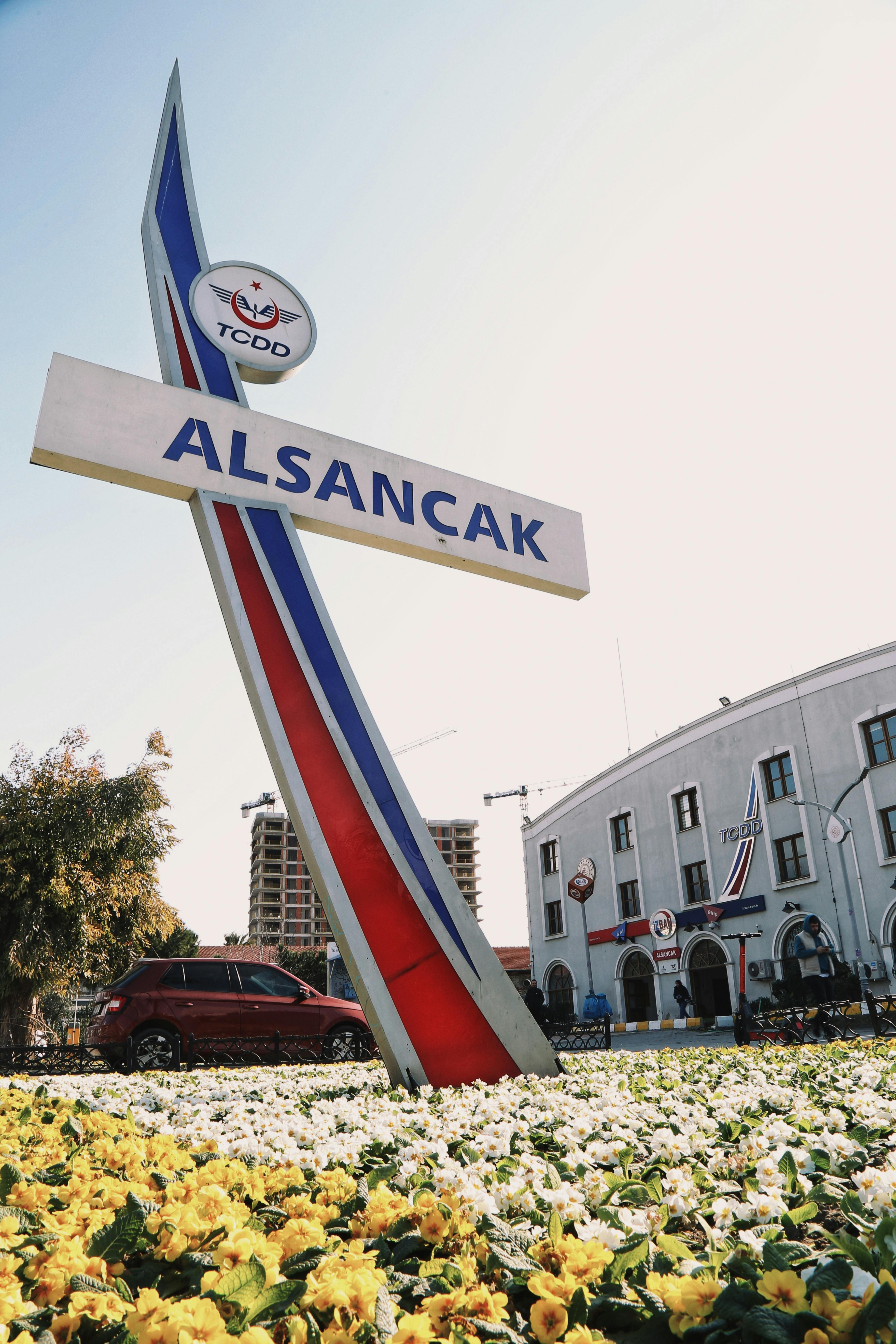 Bright view of Alsancak Railway Station sign with flowers in İzmir, Türkiye.