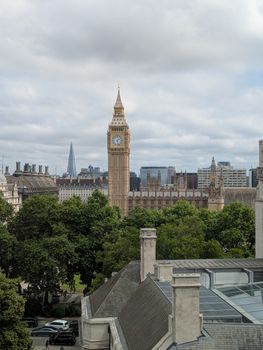 A stunning view of Big Ben amidst London's urban landscape, featuring the Shard.