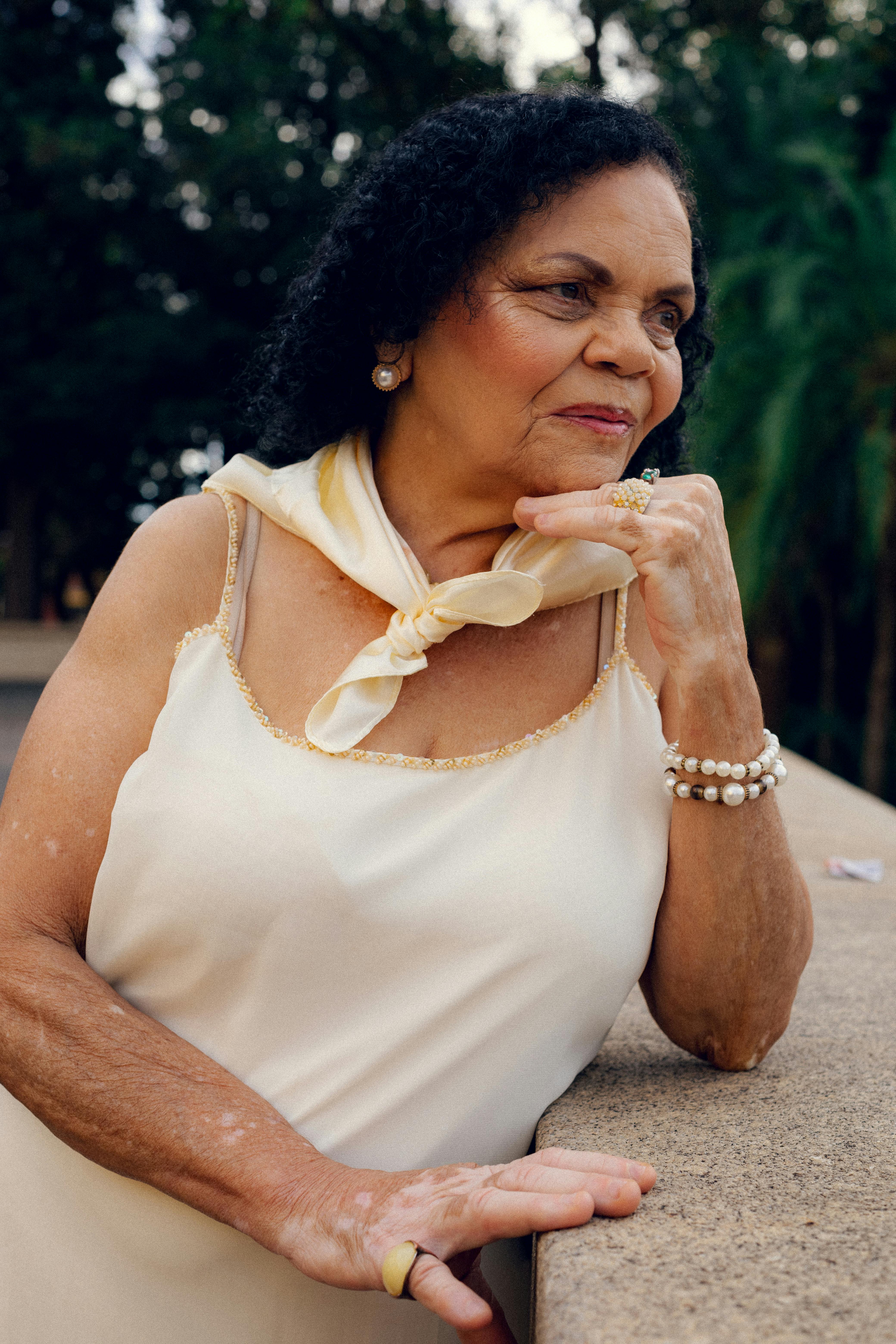 Captivating portrait of a thoughtful senior woman relaxing outdoors in São Paulo, Brazil.