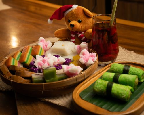 Free An inviting spread of traditional desserts and a cute teddy bear wearing a Santa hat, ideal for festive celebrations. Stock Photo