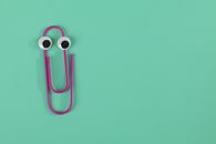 Photo of Purple Paper Clip on Green Background