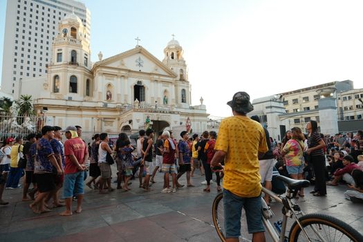 People gathering at the historic Quiapo Church in Manila, showcasing cultural and religious significance.