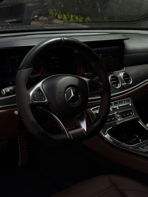 Free A detailed view of a luxury car's steering wheel and dashboard, highlighting premium design. Stock Photo