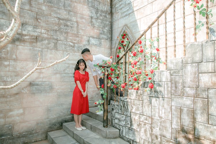 Romantic Asian Couple On Outside Marble Stairs