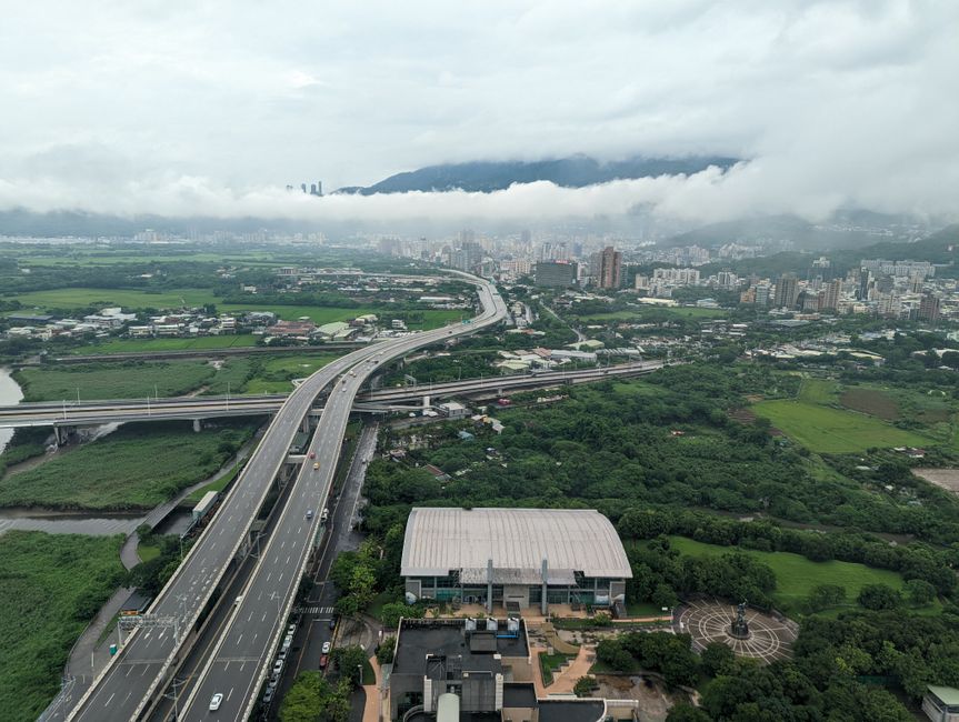 A car passing under an eTag toll gantry on a modern Taiwan freeway