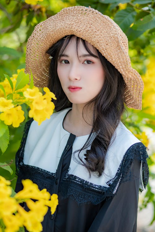 Woman Wearing Sun Hat Near Yellow Flowers
