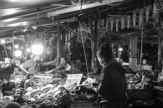 Night market textiles with a weaver — Luang Prabang