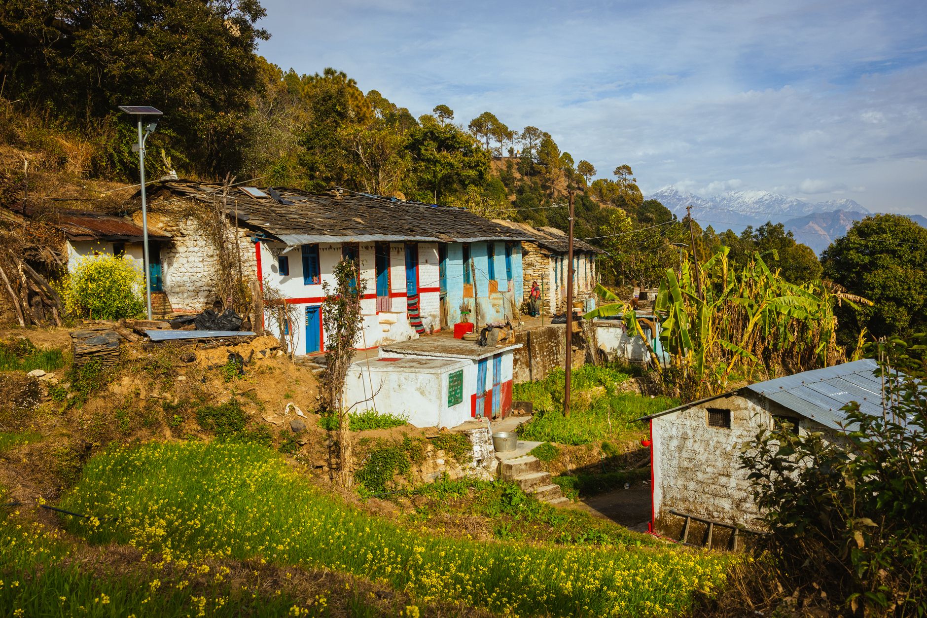 Picturesque village in Uttarakhand nestled in the Himalayas with traditional houses and lush greenery.