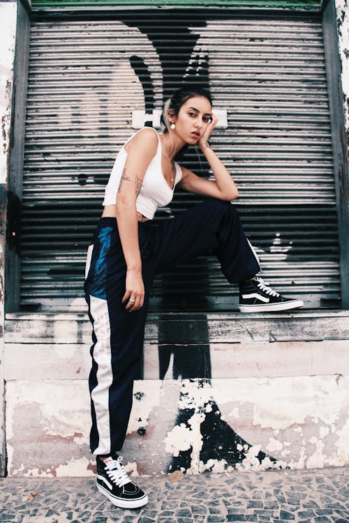 Woman in White Tank Top and Black Pants