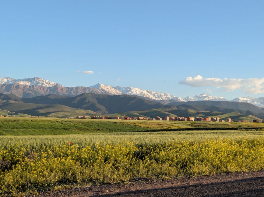 Beautiful view of the Atlas Mountains and fields in Marrakesh, Morocco during the day.