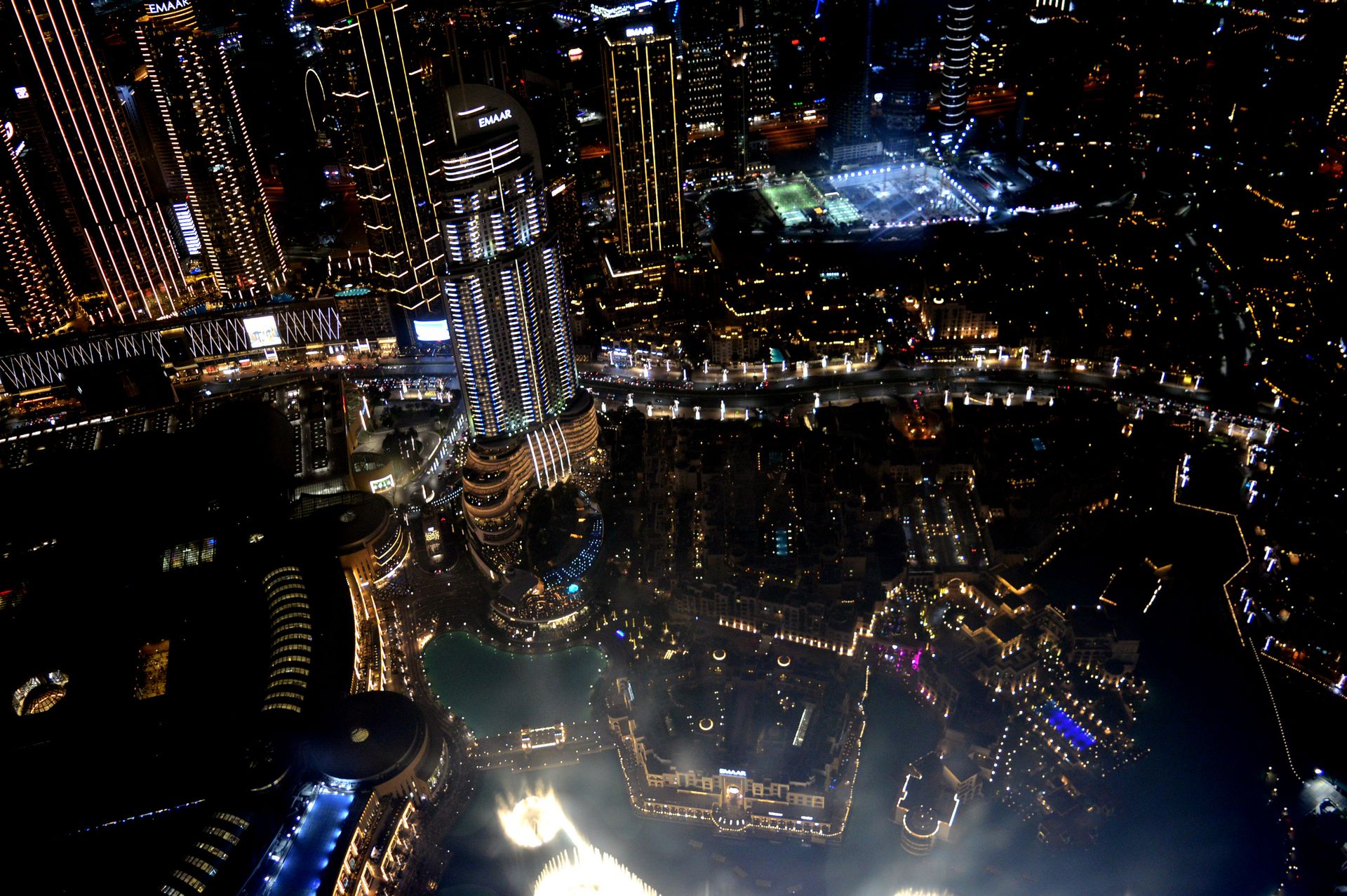 Stunning aerial view of Dubai at night showcasing the illuminated skyscrapers and bustling cityscape.