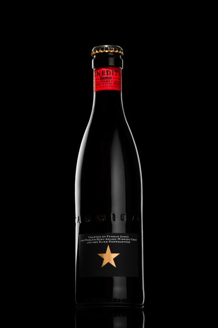 Stylish beer bottle with a red label and gold star on a black background.