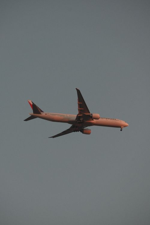 Free A passenger airplane captured flying midair during sunset, showcasing aviation marvel. Stock Photo