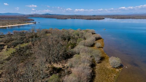 Free A breathtaking aerial view of the serene lake in Zamora, Spain, surrounded by lush nature and clear blue skies. Stock Photo