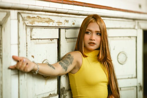 Wooden Door and Woman Tattooed Wearing Yellow Tank Top