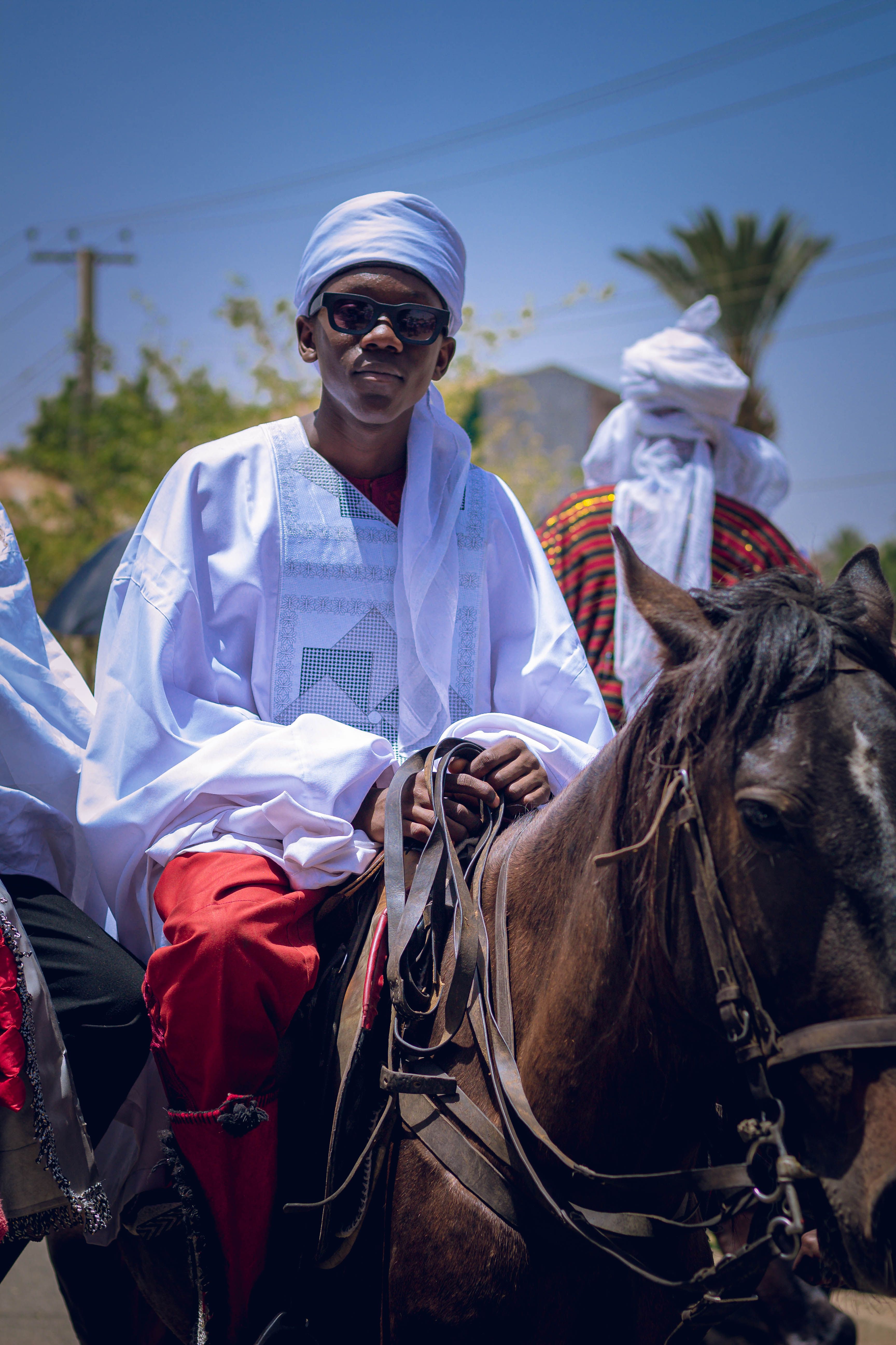 Traditional Horseback Riders in Ceremonial Attire · Free Stock Photo