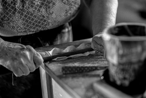 Free A close-up black and white image of an artisan using a rolling pin for crafting. Stock Photo
