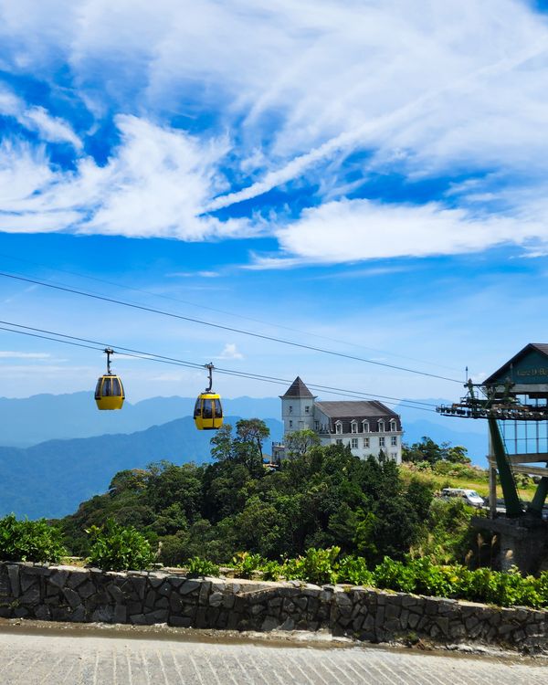 Free A picturesque scene with cable cars and a mountain resort under a vibrant blue sky. Stock Photo