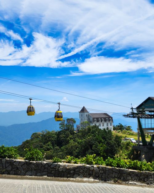 Free A picturesque scene with cable cars and a mountain resort under a vibrant blue sky. Stock Photo