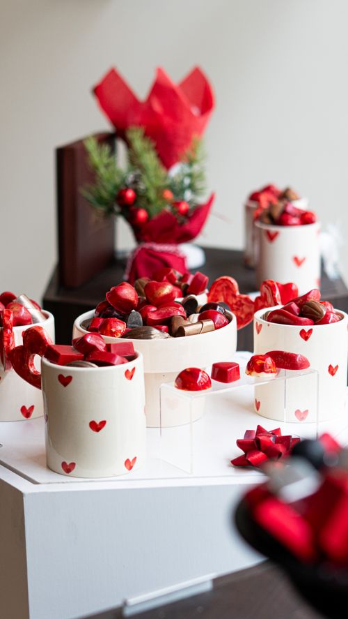 Free Assorted chocolates in heart-patterned cups, perfect for Valentine's celebration. Stock Photo