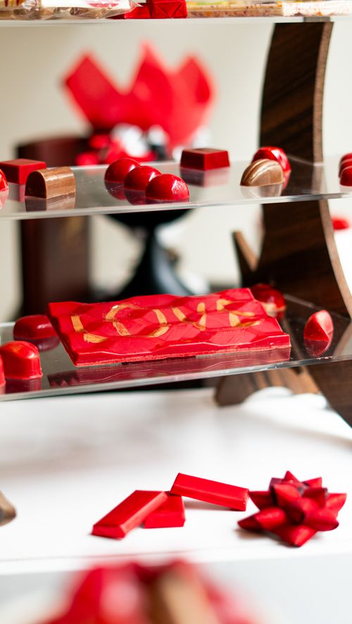 Free A colorful display of artisan chocolates with a focus on vivid red and brown hues. Stock Photo