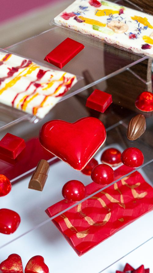 Free A vibrant array of heart-shaped and abstract chocolates elegantly displayed. Stock Photo