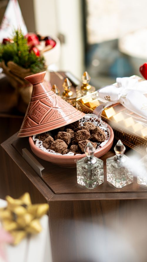 Free Elegant table setting with a Moroccan tagine filled with dried fruits. Perfect for festive occasions. Stock Photo