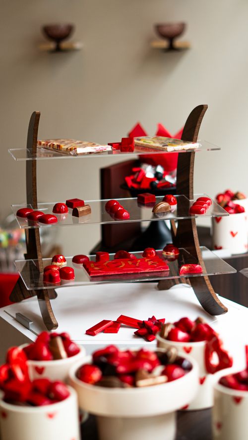 Free Elegant tiered display of assorted chocolates and sweets in a festive setting. Stock Photo