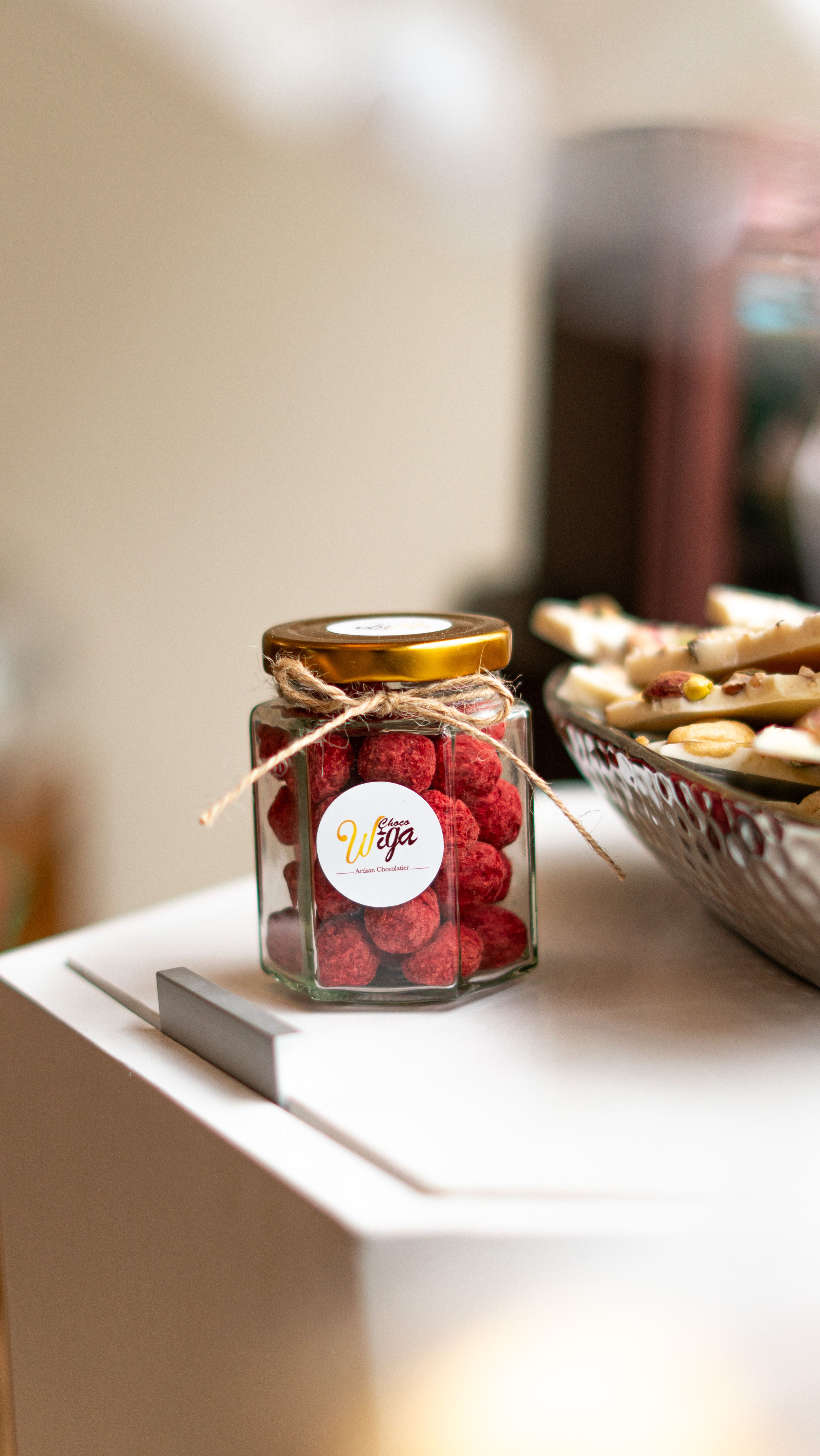 Elegantly styled glass jar filled with red dried fruits on a minimalist kitchen counter. - how to store dry fruits