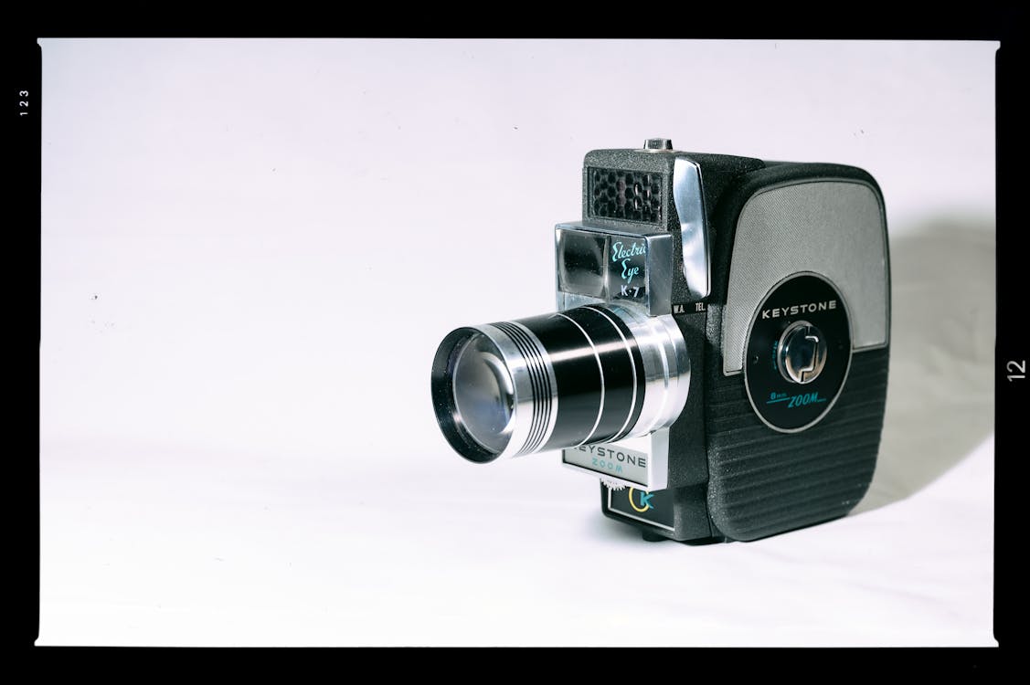 Free Black and Silver Vintage Camera on White Canvas Stock Photo