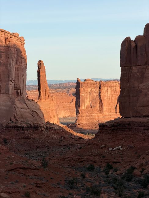 Sunrise light on sandstone arches and red rock formations in Arches National Park