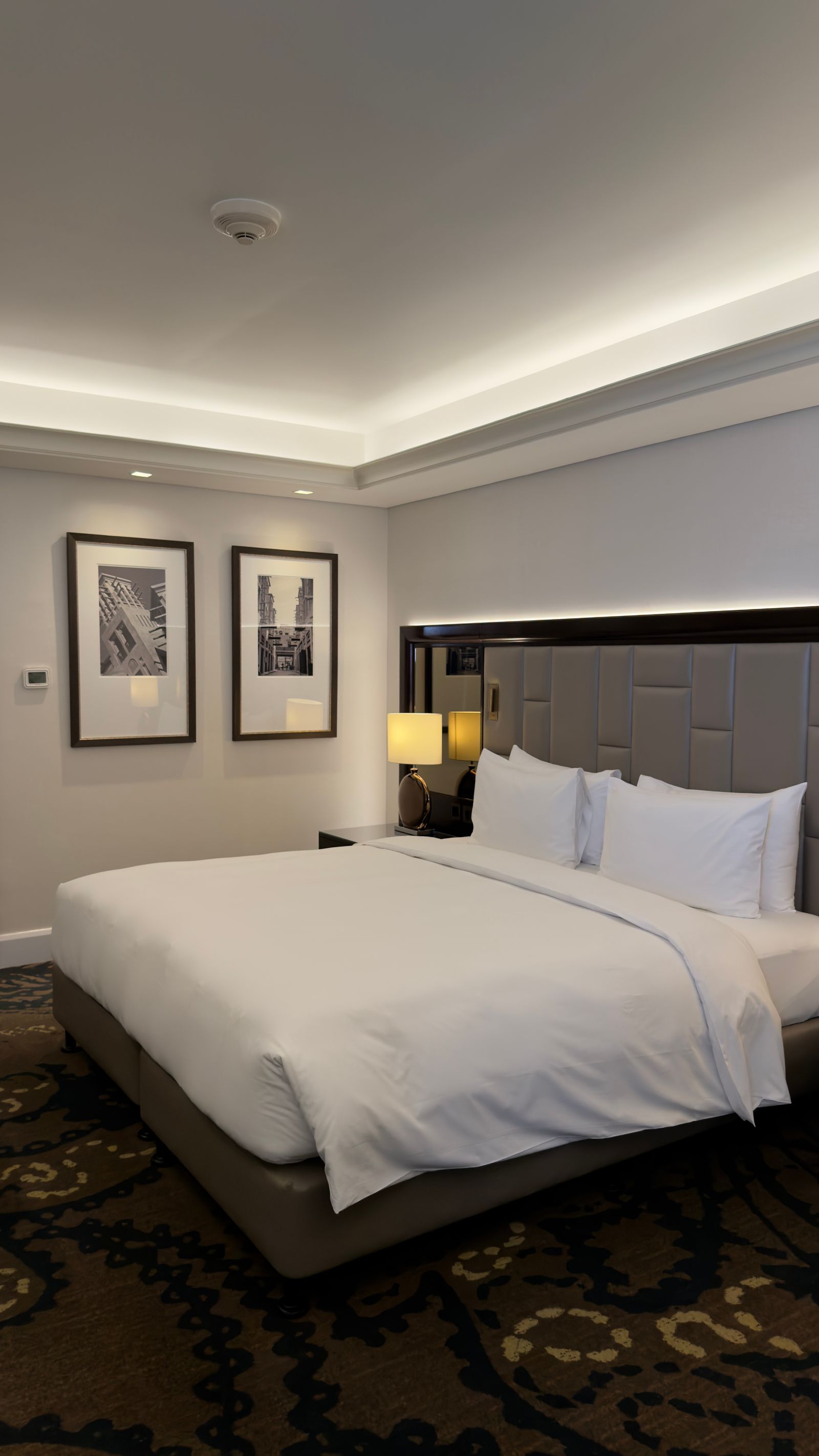 A guest room with plush bedding, ready for an out-of-town family