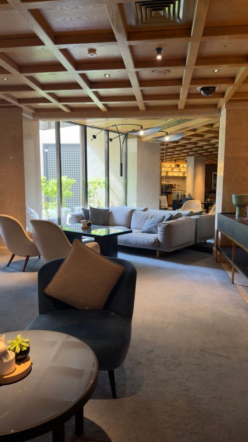 Free Elegant lounge with natural lighting, contemporary seating and decor. Stock Photo
