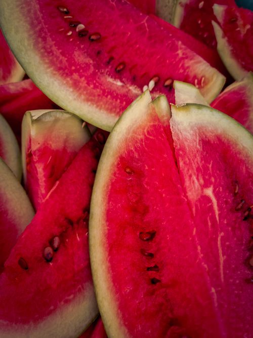 Free Vibrant close-up of fresh watermelon slices showcasing rich red color and seeds. Stock Photo