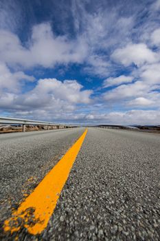 Experience the stunning perspective of the Atlantic Ocean Road under a beautiful sky in Norway.