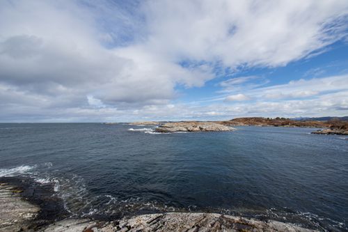 Free Breathtaking view of Norway's rocky coastline under a cloudy sky. Stock Photo